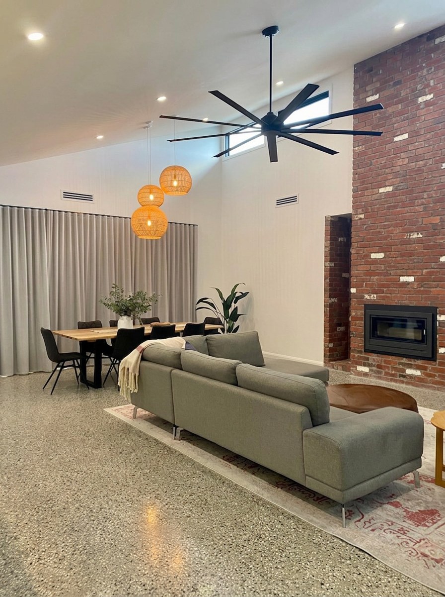 Vaulted plastered ceiling in a modern home with a brick feature wall